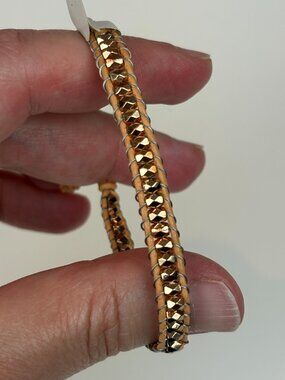 Express shimmering rose gold tone beaded leather wrap bracelet. New with tags